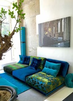 a living room filled with furniture and a potted plant