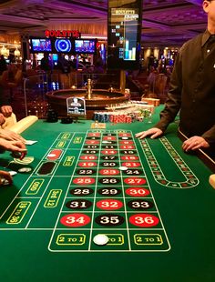 two men are playing roulejack in a casino