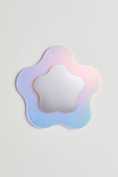 a cloud shaped mirror sitting on top of a table