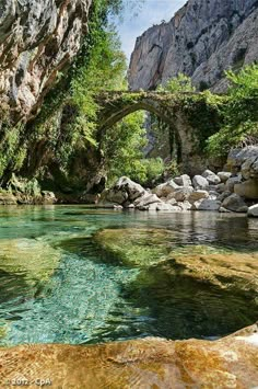 an image of a river that is in the middle of some rocks and trees on it