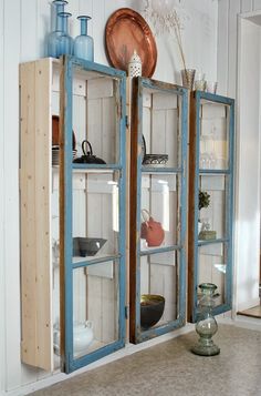 an old bookcase is being used as a display case for other items in the room