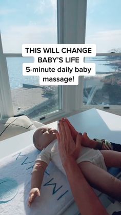 a woman holding a baby in her lap with the words, this will change baby's life 5 - minute daily baby massage