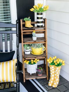 a porch with yellow flowers and potted plants on the shelf next to a chair