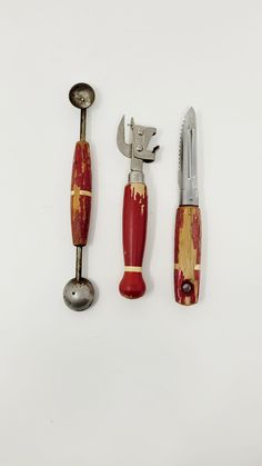 three different types of kitchen utensils on a white surface with one knife and the other tool