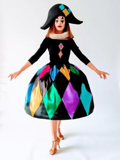 a woman in a colorful dress and black hat