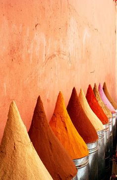 several buckets filled with different colored spices