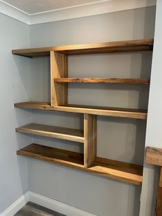 the shelves are made out of wood and ready to be put into the wall in the living room