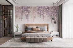 a bedroom with a large bed and purple flowers on the wall