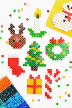 some christmas decorations made out of legos and colored pencils on a white surface