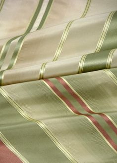 closeup of green and pink striped fabric with red stripe on the bottom right corner