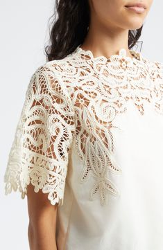 A graceful swirling pattern in guipure lace comprises the yoke and sleeves of this elegant cotton-and-silk top. 22" length (size 8) Back keyhole with button-and-loop closure Jewel neck Short sleeves 70% cotton, 30% silk Dry clean Imported Elegant Summer Lace Top In Cotton Lace, Elegant Cotton Lace Patchwork Tops, Elegant Cotton Lace Top For Summer, Elegant Summer Cotton Lace Top, Elegant Cotton Lace Top With Lace Collar, Elegant Cotton Lace Top, Elegant Summer Lace Crochet Top, Elegant Summer Crochet Lace Top, Elegant Short Sleeve Scalloped Lace Top