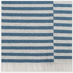 a blue and white striped rug with fringes on the bottom, in two different colors