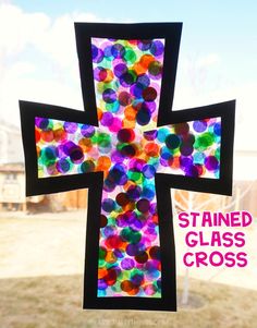 the stained glass cross is hanging outside