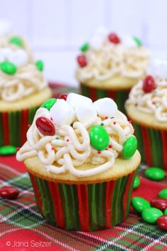 cupcakes with white frosting and candy on top