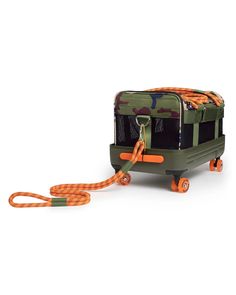 a green and orange dog carrier on wheels with an orange leash attached to the front