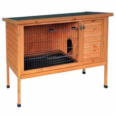 a wooden rabbit hutch with a black roof