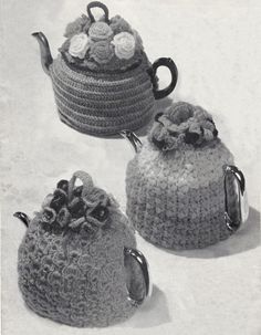 three crocheted teapots are shown in this black and white photo, one has a flower on the top