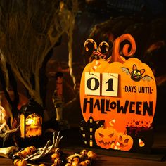 a number one sign sitting on top of a table next to pumpkins and candles