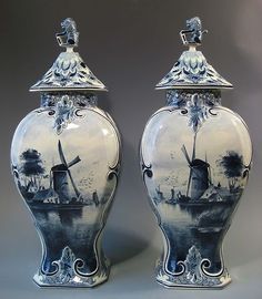 two blue and white vases sitting next to each other