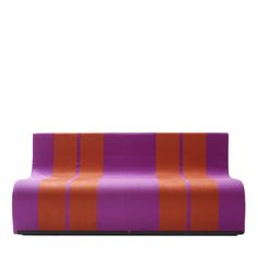 an orange and purple striped couch sitting on top of a white floor next to a wall