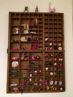 a wooden shelf filled with lots of different types of items on top of each other