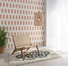 a chair sitting on top of a rug in front of a wall mounted light fixture