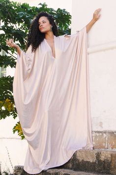 Introducing the Rudy Kaftan from our Regal Collection, an exquisite piece crafted from a glossy ruby fabric. With its multiple arm holes and V neck, you can style this garment your way for an effortless, sophisticated look. Our model is 5'6, and is wearing our One Size Fits All. We offer world wide international shippi Dubai Fits, Kaftan Moroccan Caftan, Virgo Style, Goddess Gown, Trinidad Tobago, Moroccan Caftan, Gold Fabric, Casual Chic Outfit, Back Women