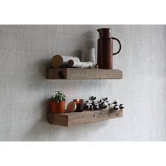 two wooden shelves with pots and plants on them, one holding a coffee pot and the other holding a teapot