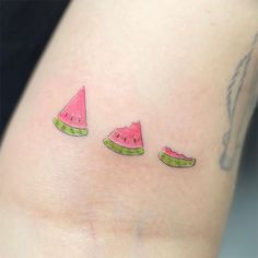 three slices of watermelon on the side of a woman's leg with small tattoos