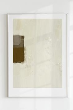 an abstract painting hangs on the wall next to a white vase with a plant in it