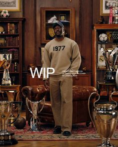 a man standing in front of a couch with trophies around him and the words wip written on it