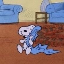 a drawing of a cartoon character sitting on the floor in front of two blue couches