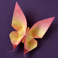 an origami butterfly on a purple background