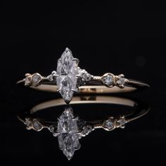 an engagement ring with three pear shaped diamonds