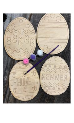 four wooden coasters with painted eggs and the words hello kitty on them, along with two knitting needles