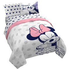 a bed with minnie mouse comforter and sheets