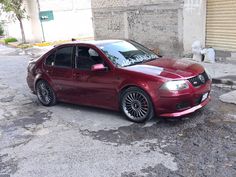 a red car parked in front of a building