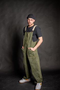 High quality cotton olive green denim baggy overall for men & women, heavy weight durable cotton fabric, although breathable and comfortable to wear all day. Wear it at work or even as your street wear clothes, cause it's fashionable and stylishly designed for your social life as well! -Four pockets total, functional and roomy enough to fit small tools, keys, even your mobile phone. Two front and two back pockets. -Metal bronze studs and dungaree metal clip fasteners. -Adjustable cotton beige st Green Cotton Shortalls With Pockets, Cotton Utility Overalls With Bib Front, Utility Cotton Overalls With Bib Front, Khaki Cotton Utility Overalls, Baggy Cotton Overalls With Side Pockets, Cotton Bib Front Overalls For Outdoor, Green Bib Front Overalls With Pockets, Relaxed Fit Cotton Utility Overalls, Utility Cotton Overalls With Relaxed Fit