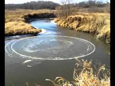 an image of a river that is in the middle of some grass and water with circles drawn on it