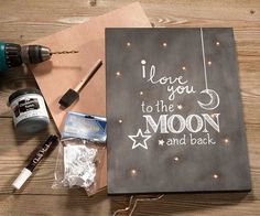 some crafting supplies are laying out on a wooden table with the words i love you to the moon and back