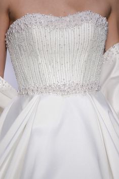 the back of a wedding dress with beading on it