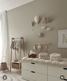 a baby's room is decorated in neutrals and whites