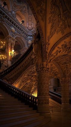 an ornate staircase with chandeliers in a building