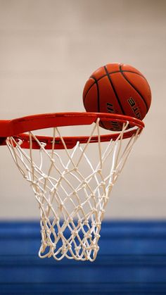 a basketball is going through the hoop with an inspirational quote above it that reads, the main goal of basketball is to shoot more balls into your basket / hoop