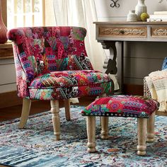 a colorful chair and footstool in front of a desk with a lamp on it