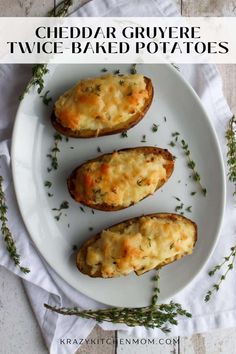 three cheddar gruyere twice baked potatoes on a white plate with herbs