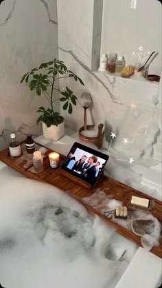 a bathtub with candles and soaps in it