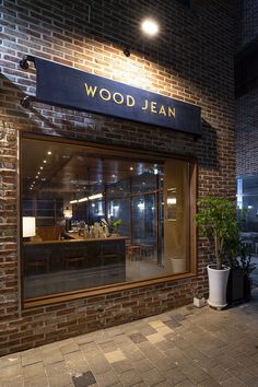 a brick building with a sign that reads wood jean