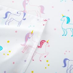 two sheets with unicorns and stars on them