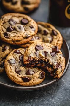 chocolate chip cookies on a plate next to a cup of coffee